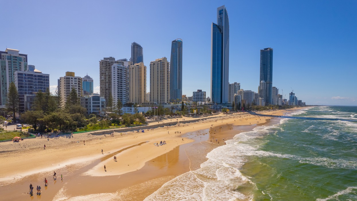 A beachfront with skyscrapers in the background