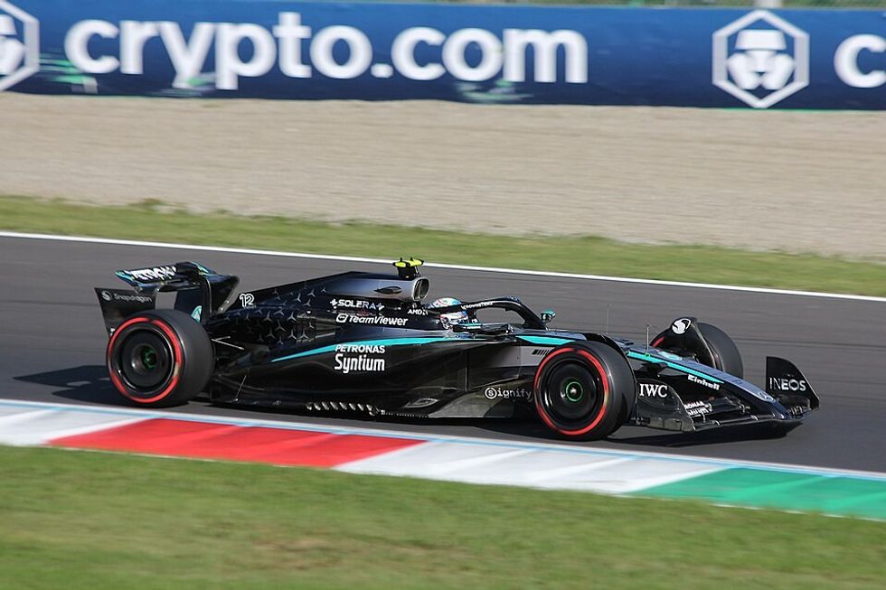 A black Formula 1 car on the track