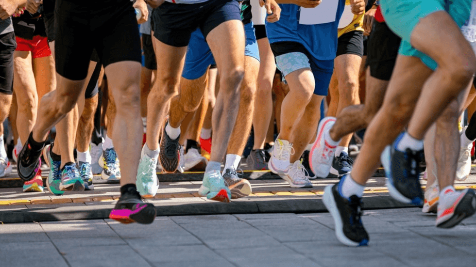 A bunch of runners legs running in a race