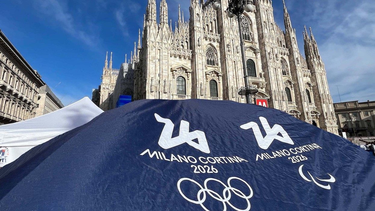 A cathedral in Milan with the Olympic heraldry in the foreground