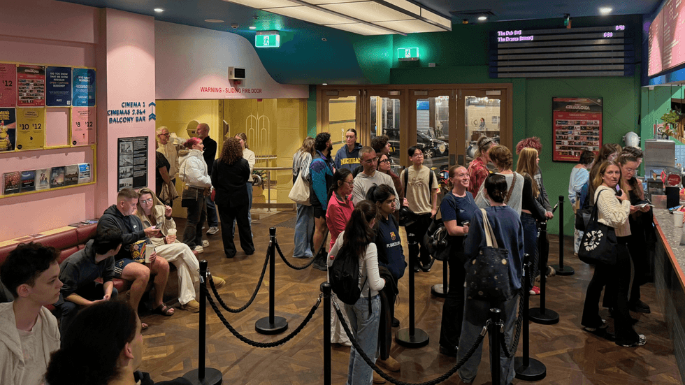 A cinema foyer crowded with young people