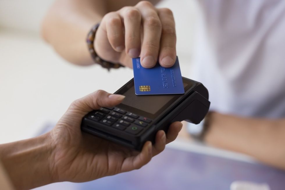 A close up of a card being tapped on an eftpos machine
