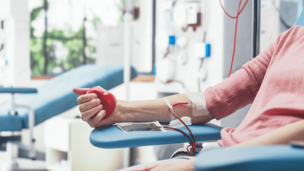 A close up of a female arm giving blood