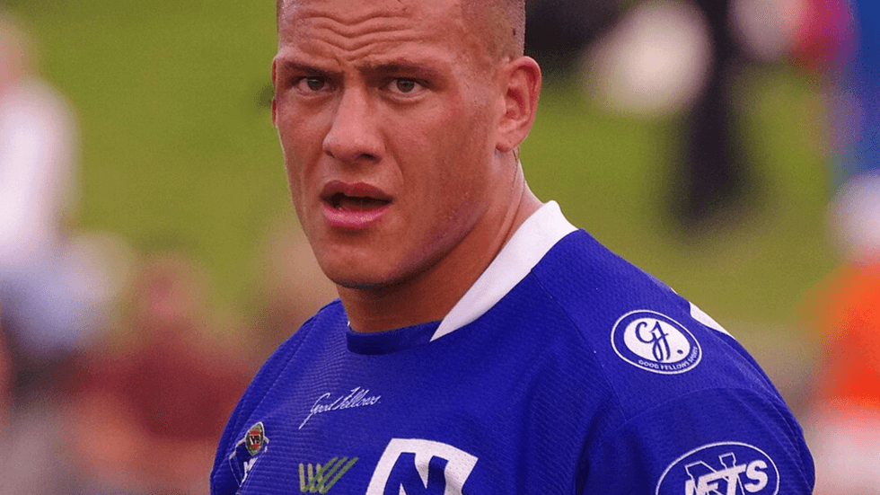 A close up of a football player wearing a blue team shirt