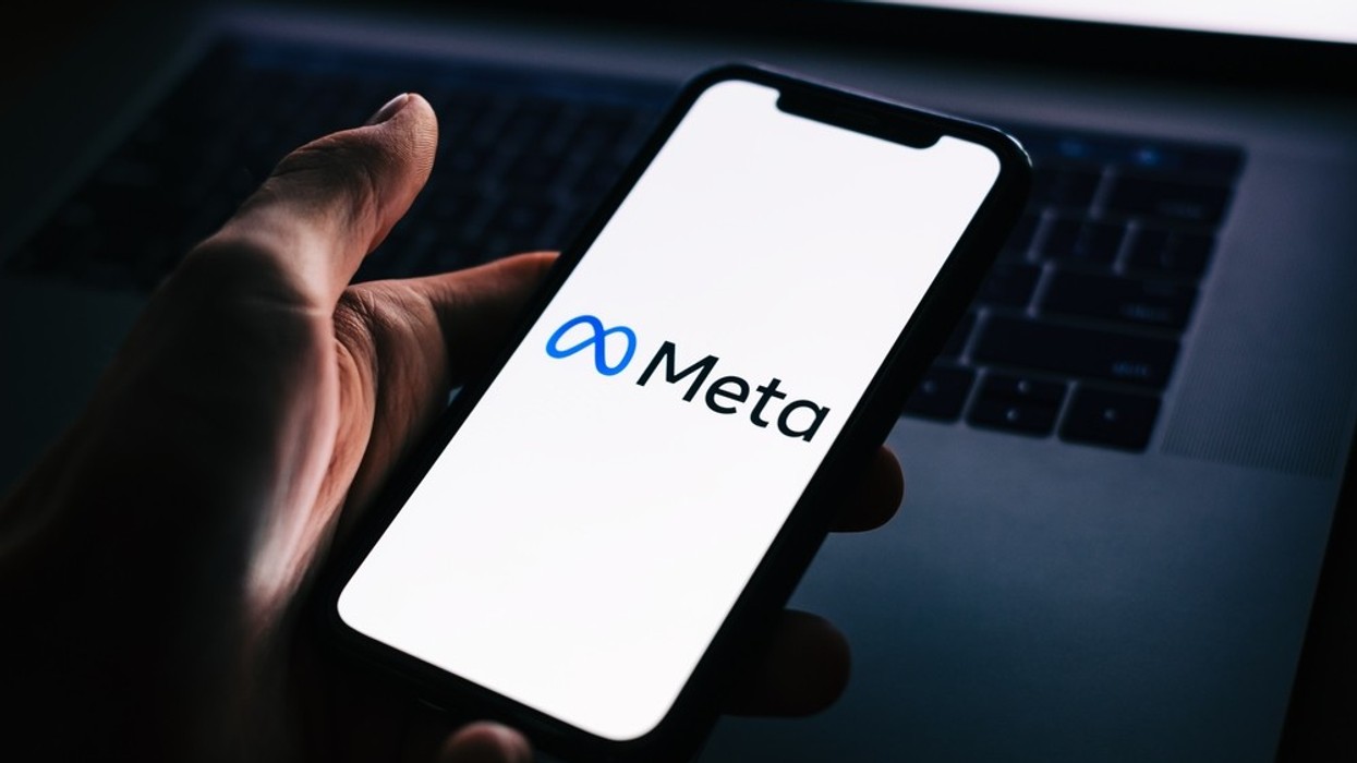 A close up of a phone saying Meta on the screen.