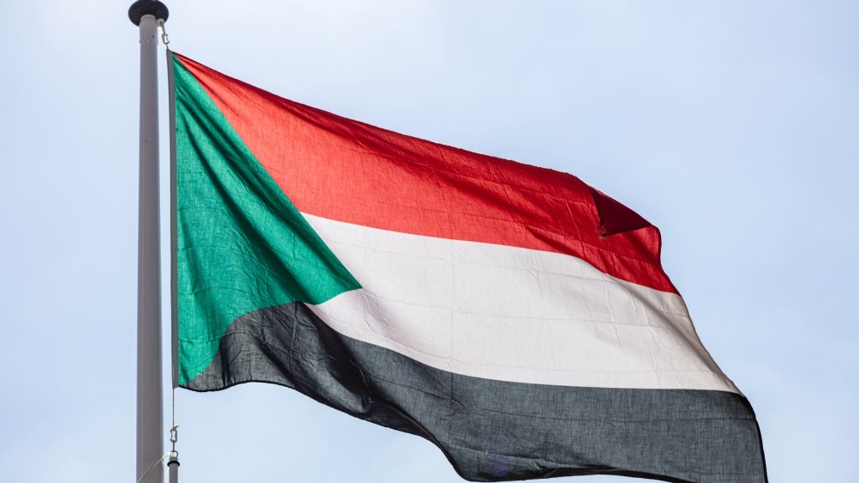 A close up of the red, white, green and black Sudanese flag.