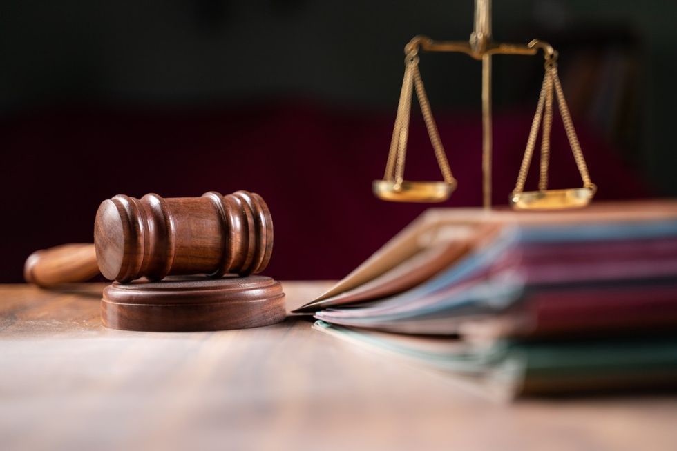 A court gavel, some books, and the scales of justice