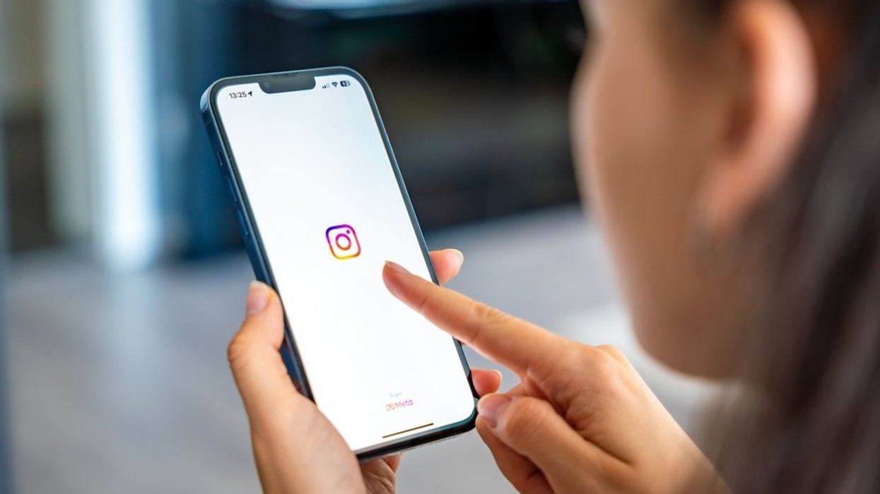 A female figure looking at Instagram