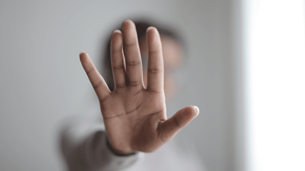 A female hand indicating stop