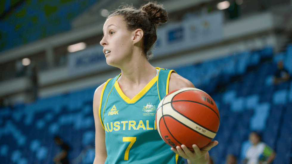 A female netball player holding a ball