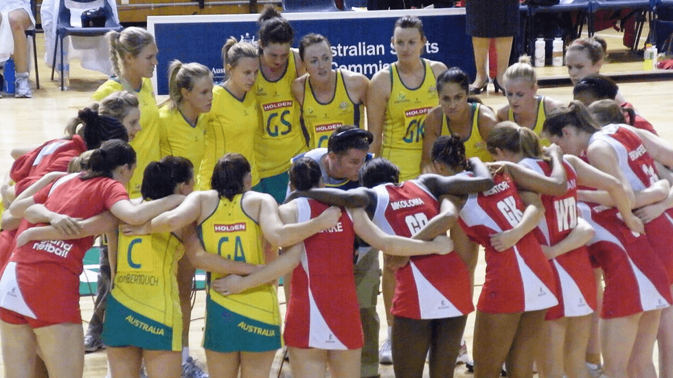 A group of female netball players in a huddle