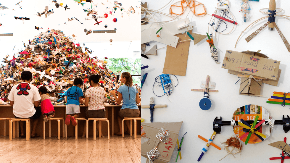 A group of people sit at a craft table creating artworks