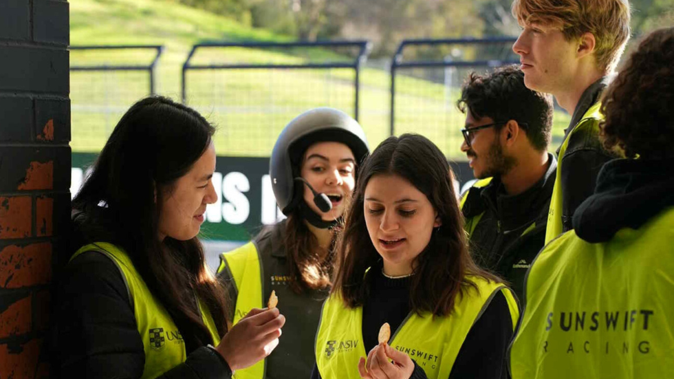 A group of young people wearing fluoro jackets