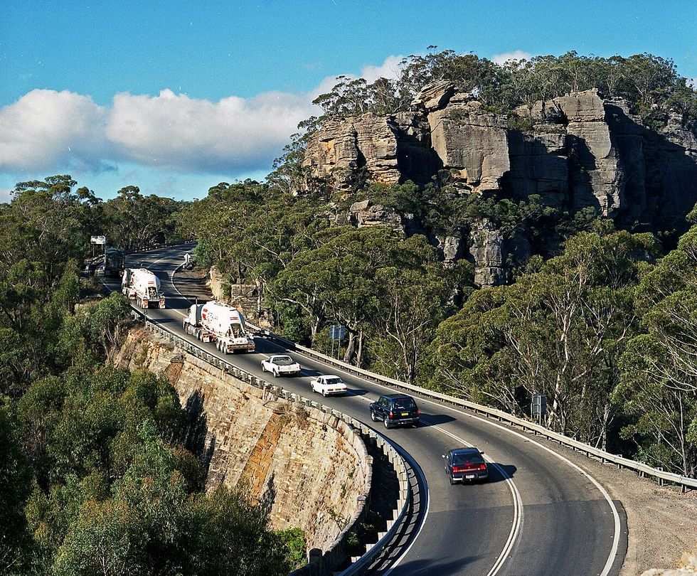 A line of cars along a mountainous highway