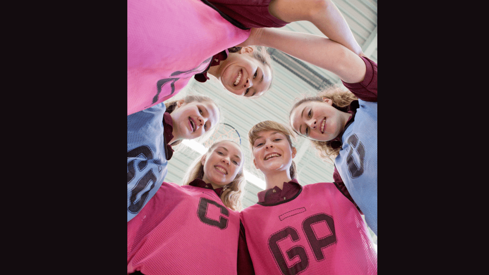A low shot of a group of young female netball players