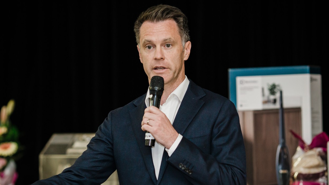 A man in a suit holding a microphone