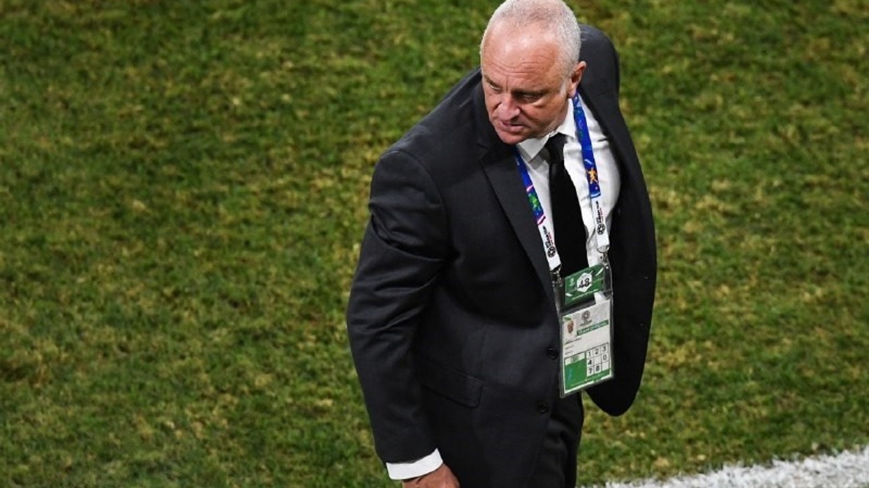 A man in a suit on a football field