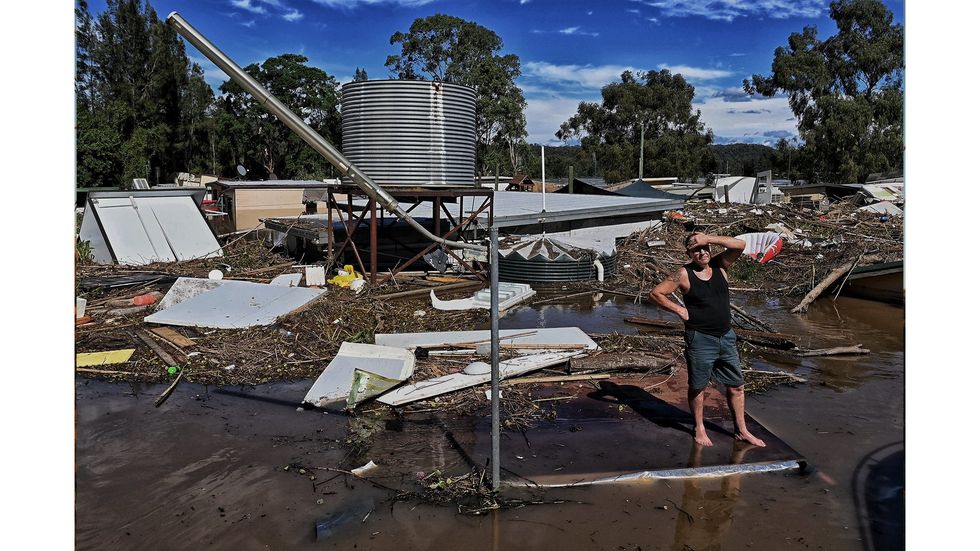 A man stands on his roof after the Hawkesbury floods.