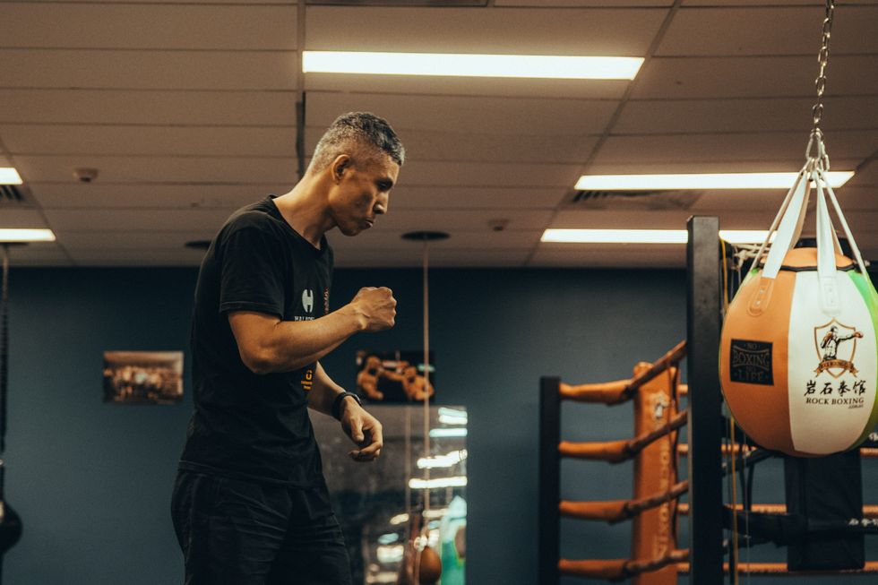 A man training with a boxing ball