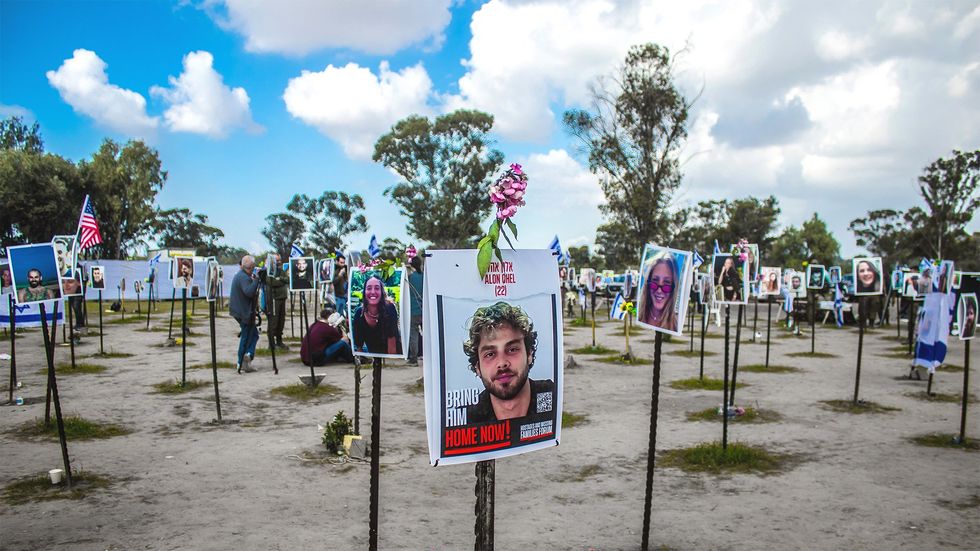 A memorial field of posters with the faces of Israelis killed on October 7, 2023.