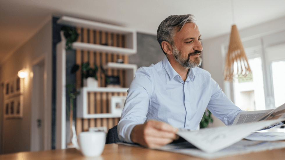 A middle aged man reading the news