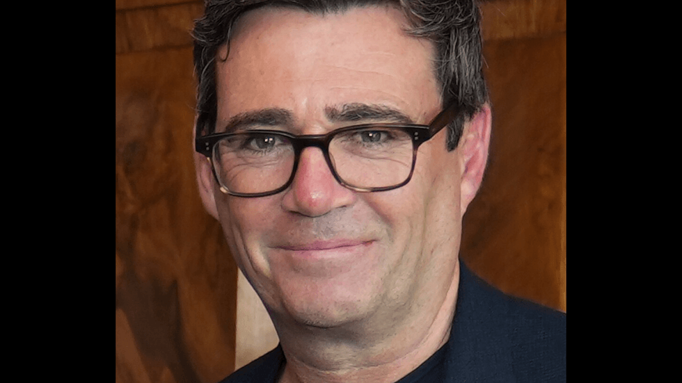 A middle aged man with brown hair and glasses