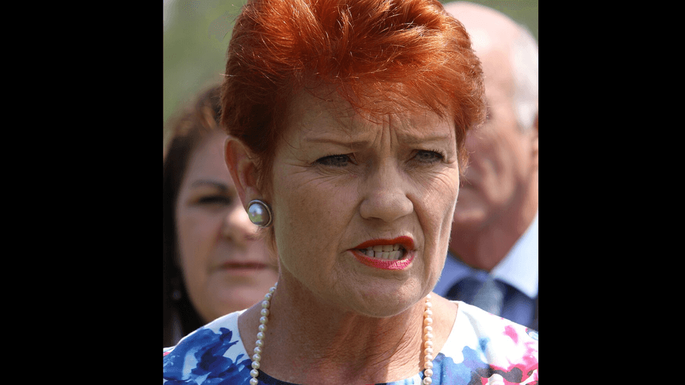 A middle aged woman with red hair and red lipstick