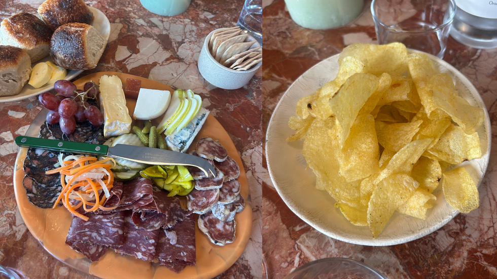 A plate of charcuterie and a plate full of crisps