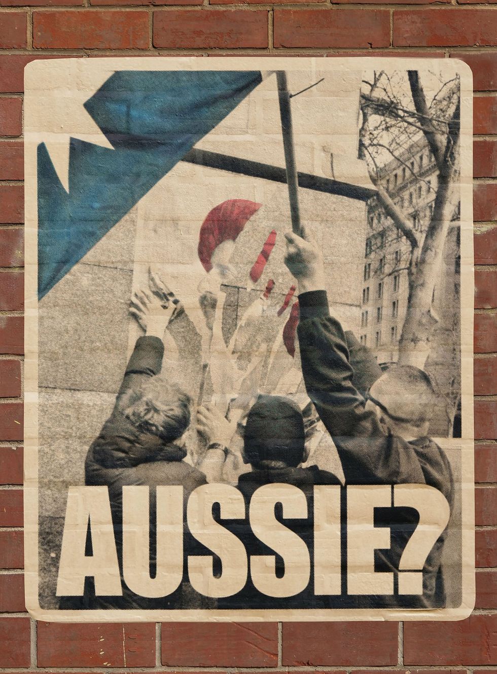 A poste of people pulling down a poster