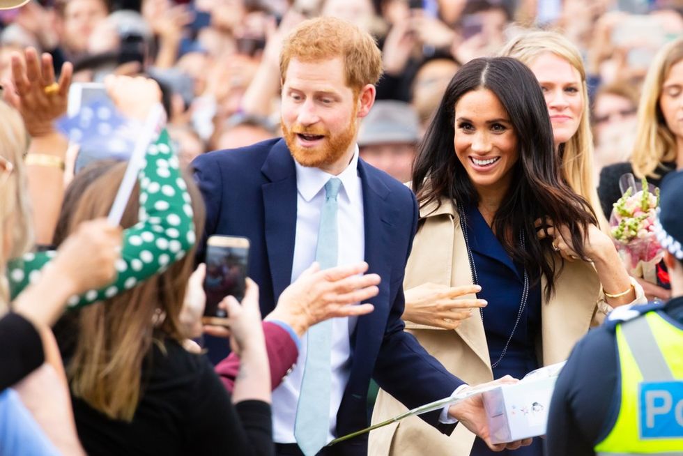 A red-haired man and a woman with dark hair in the middle of a crowd
