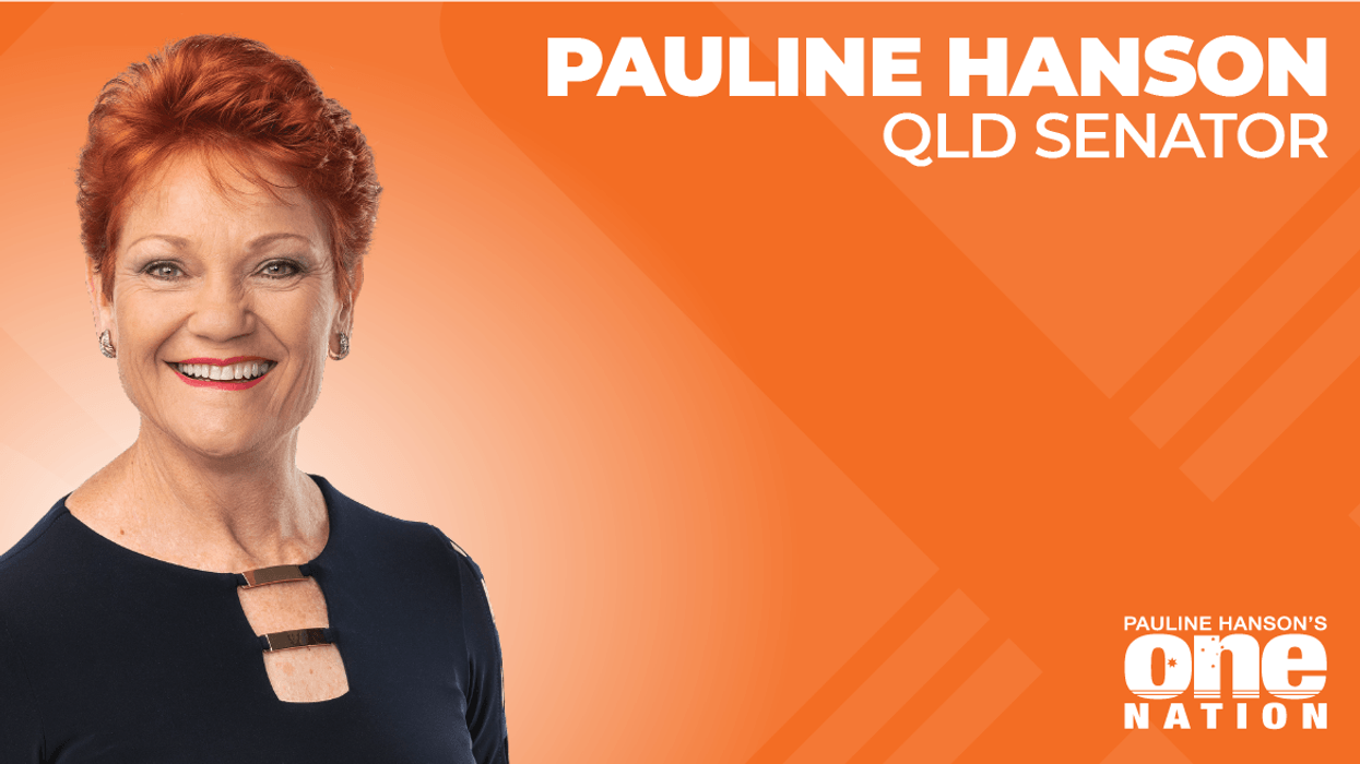 A red haired woman smiling at the camera