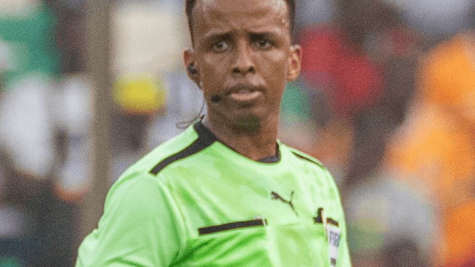 A referee wearing a brightly coloured uniform