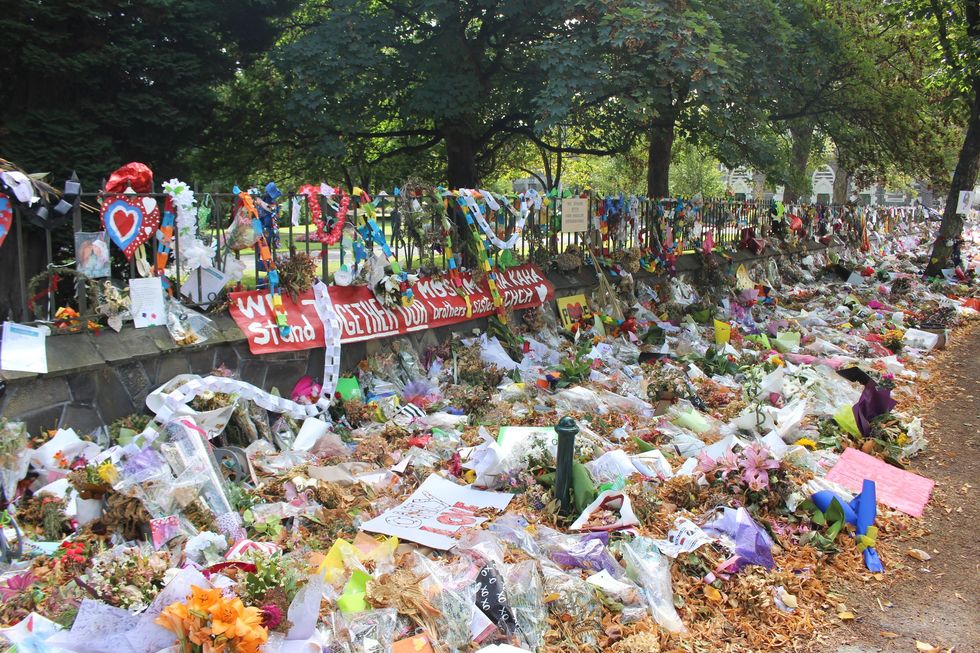 A roadside memorial covered in flowers