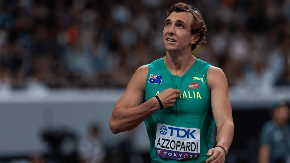 A runner in a green top looks at the crowd