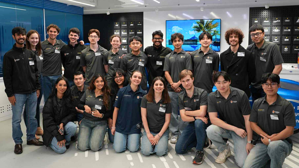 A team shot of young students smiling at the camera