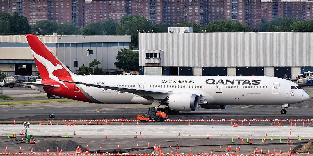 A wide shot of a plane on the tarmac