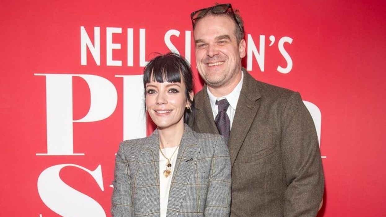 A woman and man smile at the camera