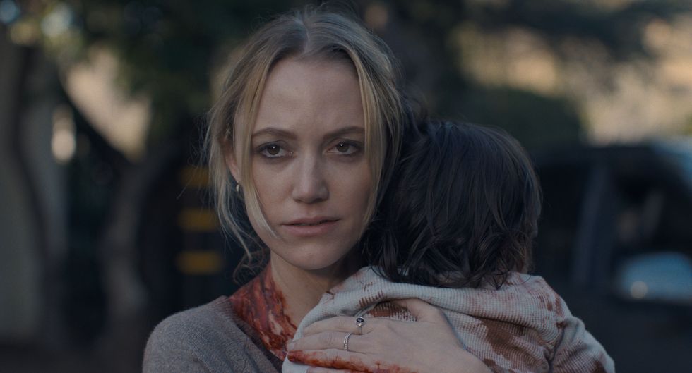 A woman holds a small baby