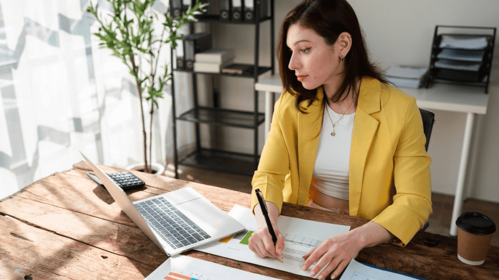 A woman looking at her laptop