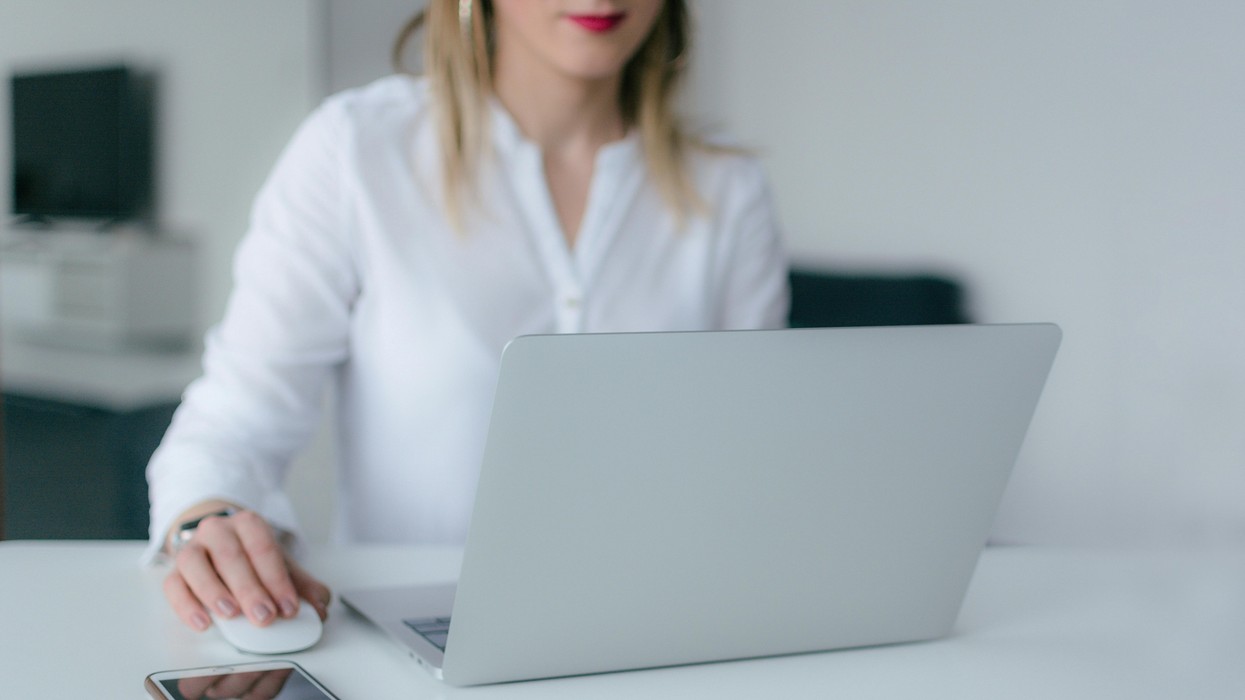 A woman sitting in front of a laptop