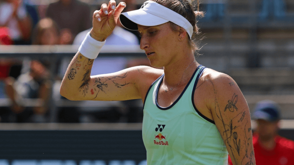 A woman tennis player wearing a cap