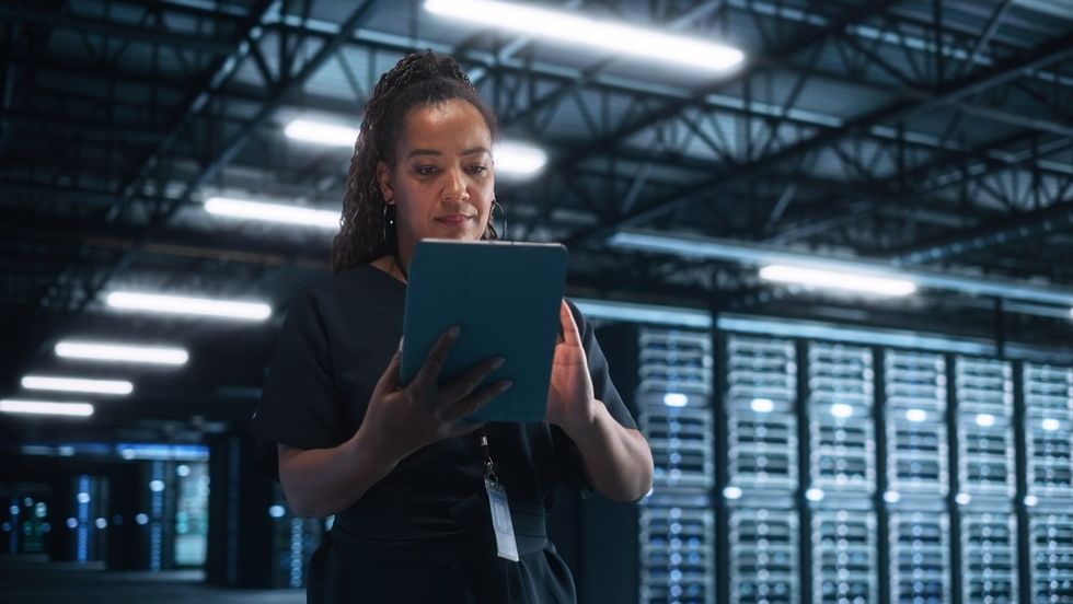A woman walking through a data centre