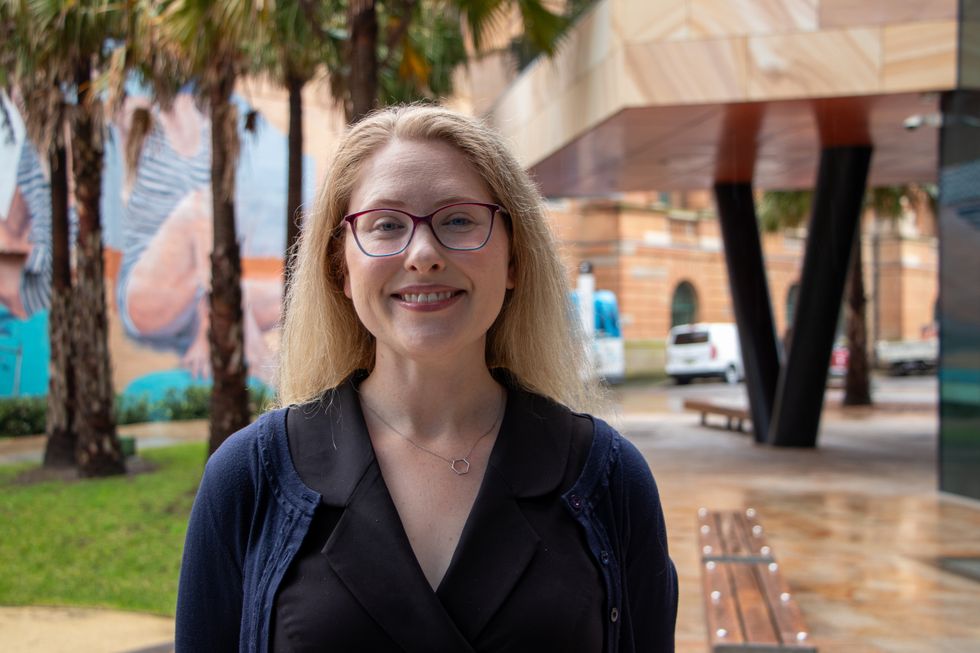 A woman with blonde hair smiles at the camera