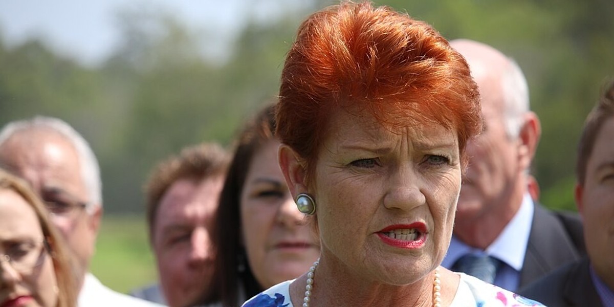 A woman with orange hair speaking