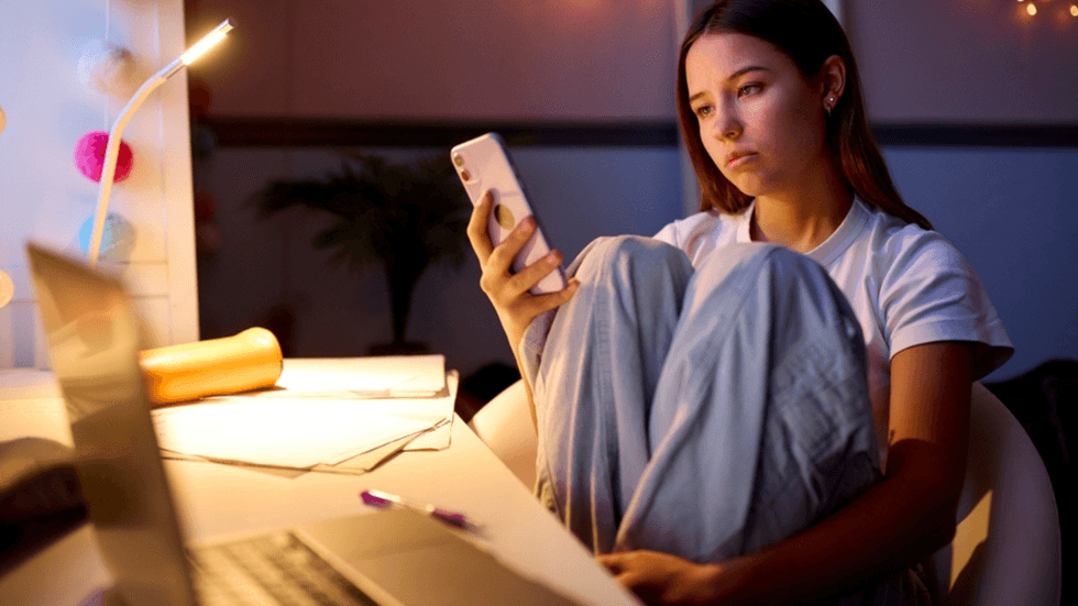 A young woman staring at her phone