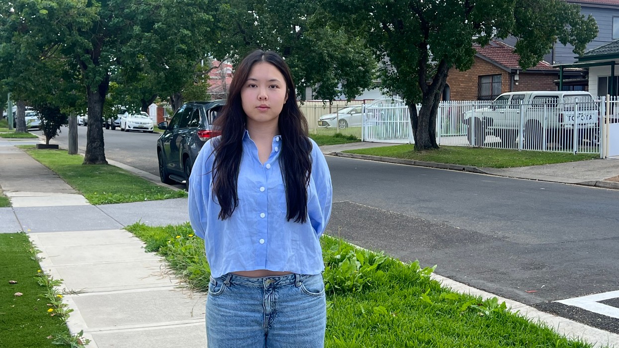 A young woman wearing a blue shirt and jeans
