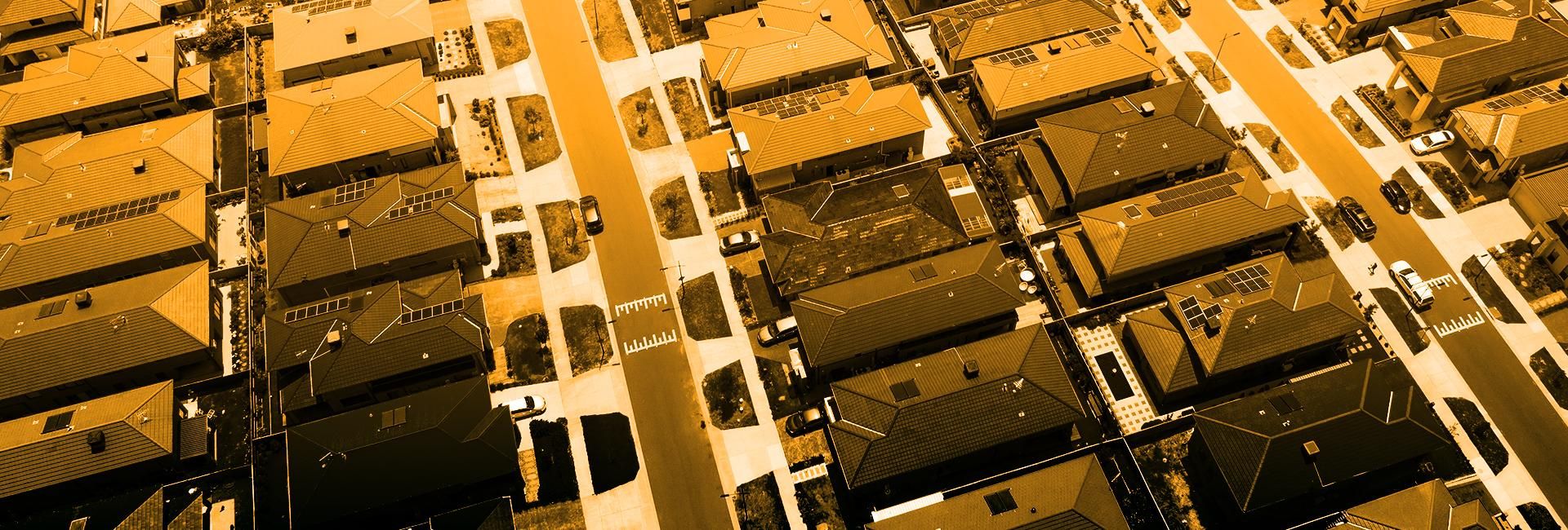 Aerial image of closely-pack suburban roof tops in an Australian city.