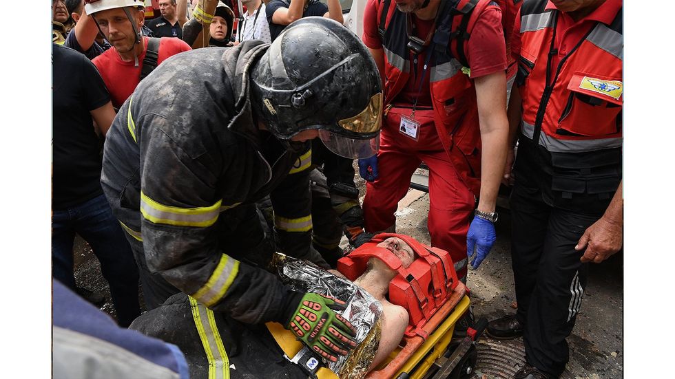An injured woman in Ukraine is attended to by paramedics.