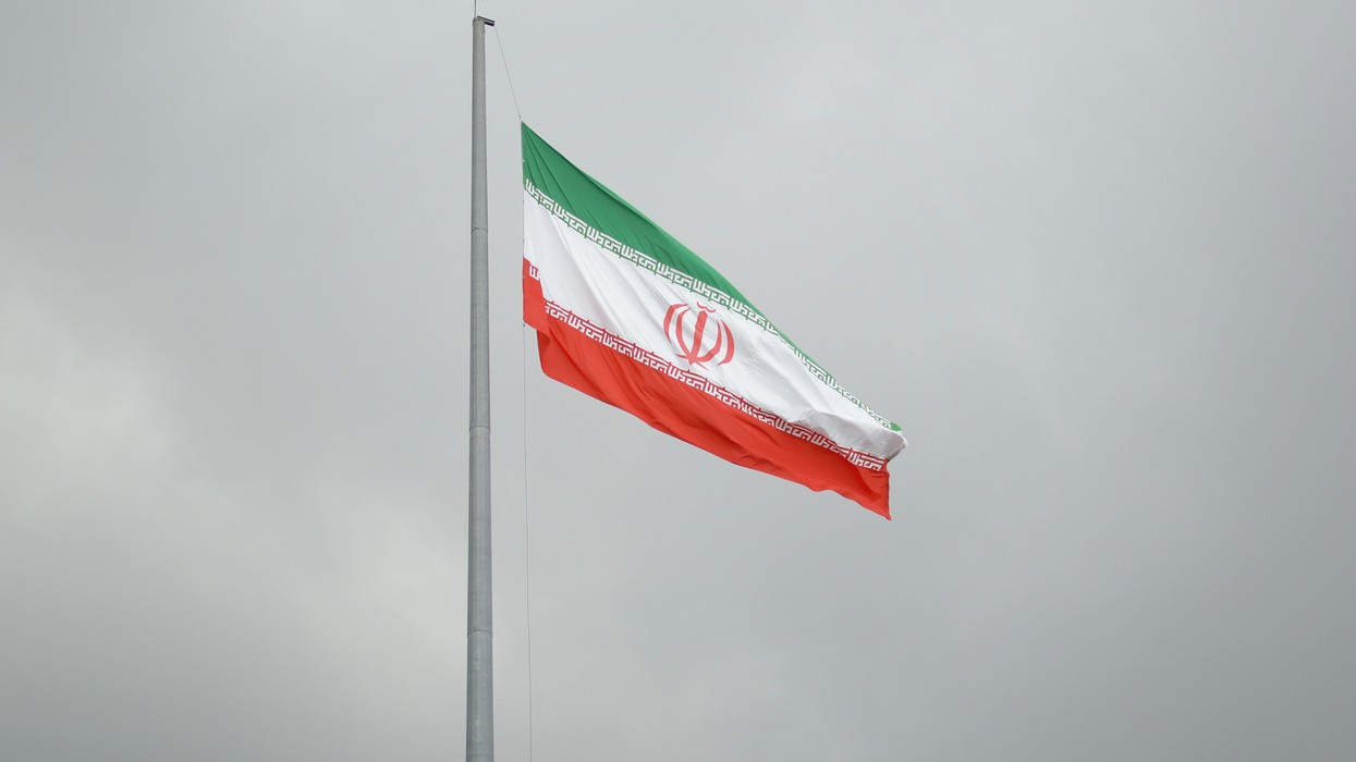 An Iranian flag on a flag pole
