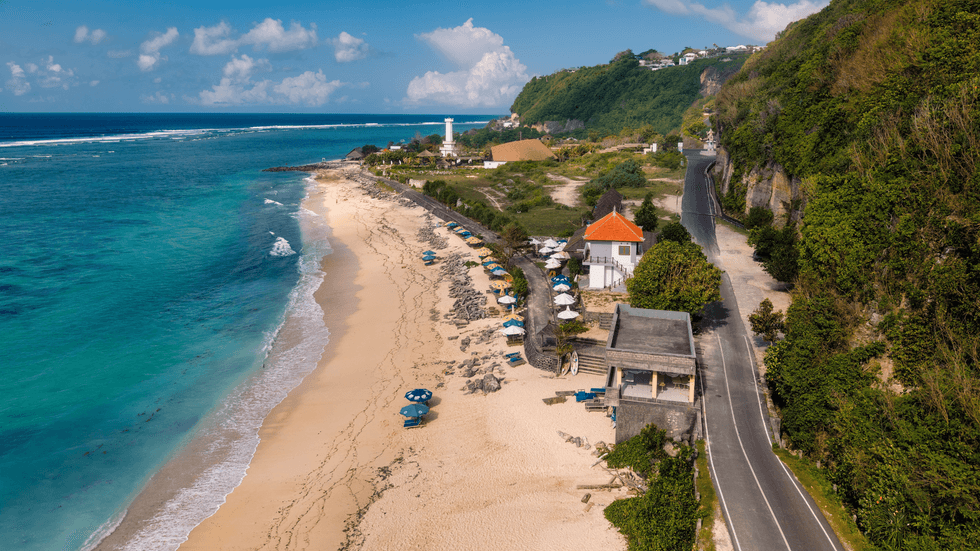 An overhead shot of a beach front with umbrellas